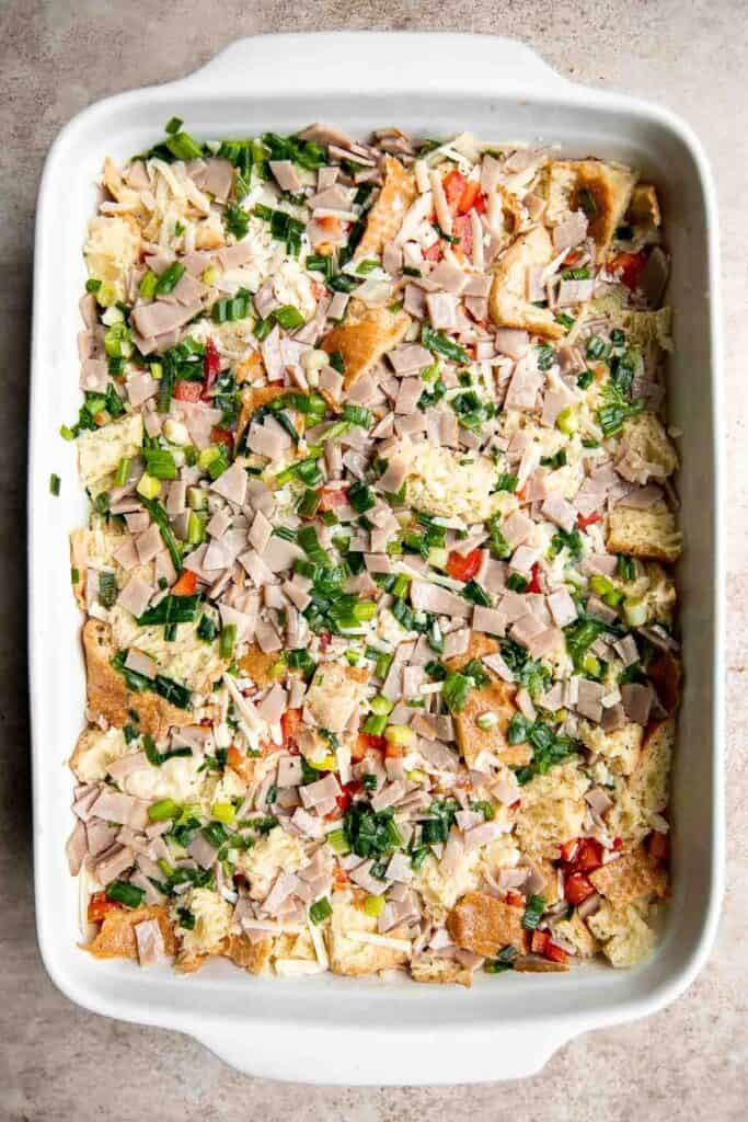 Breakfast Strata is a hearty baked casserole dish loaded with bread, eggs, ham, cheese, and veggies that will keep you full until lunchtime. | aheadofthyme.com