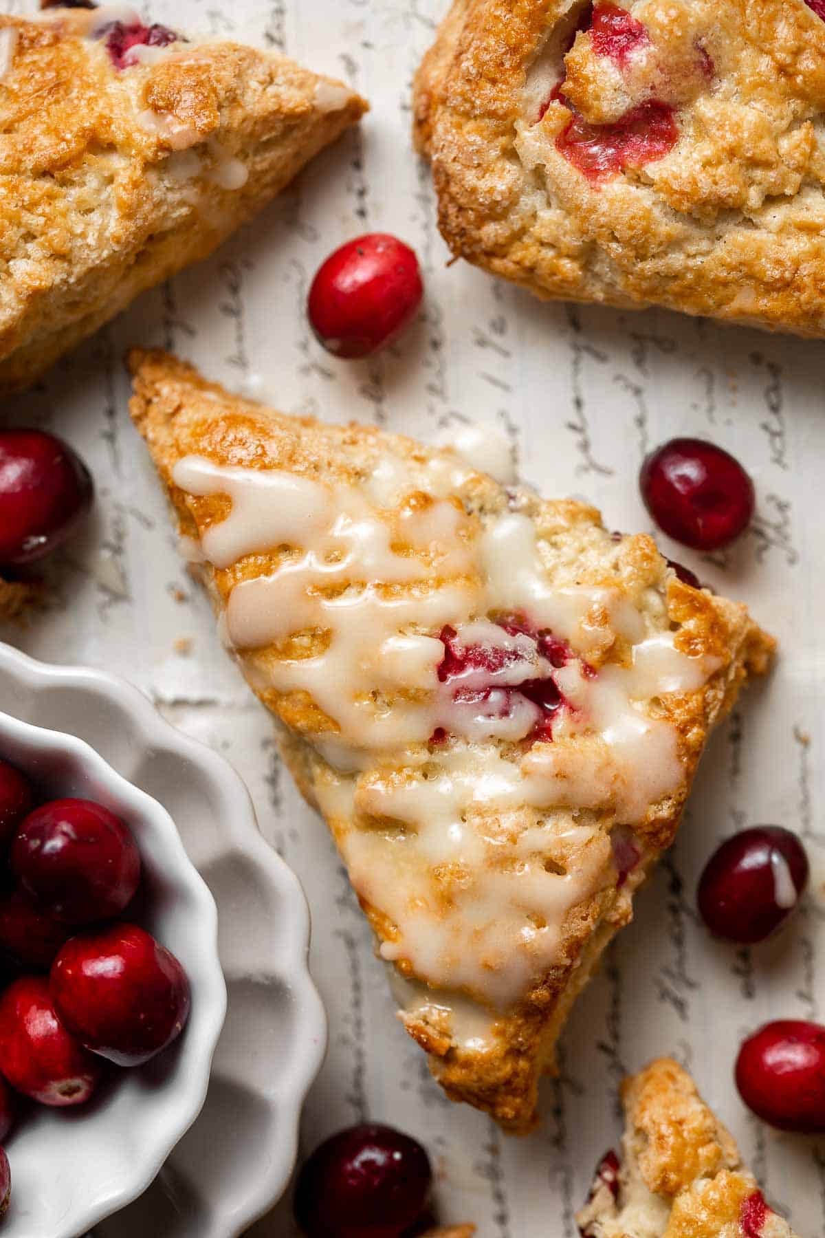 Cranberry Scones with Orange Glaze are a quick and easy holiday brunch recipe that is flavorful and flaky. They're soft and moist inside yet crisp outside. | aheadofthyme.com