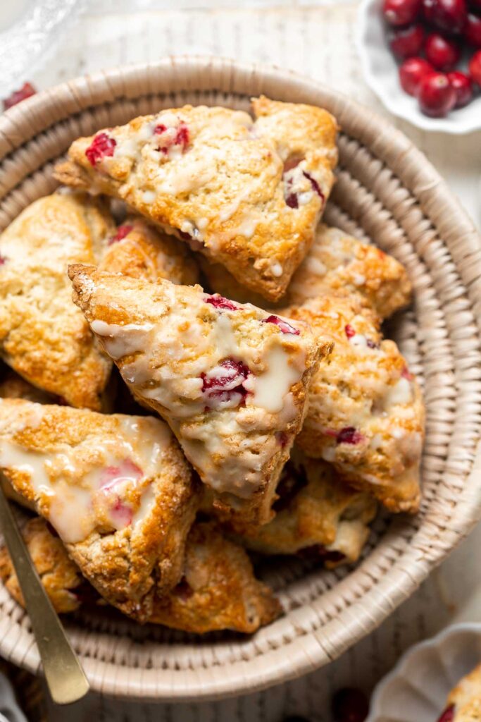 Cranberry Scones with Orange Glaze are a quick and easy holiday brunch recipe that is flavorful and flaky. They're soft and moist inside yet crisp outside. | aheadofthyme.com