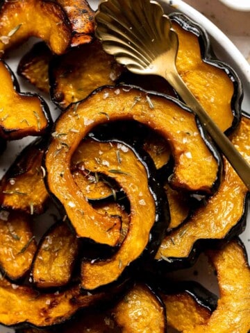 Maple Roasted Acorn Squash is savory and sweet, with its flavor intensified when tossed and roasted in a homemade maple glaze with a sprinkling of cinnamon. | aheadofthyme.com