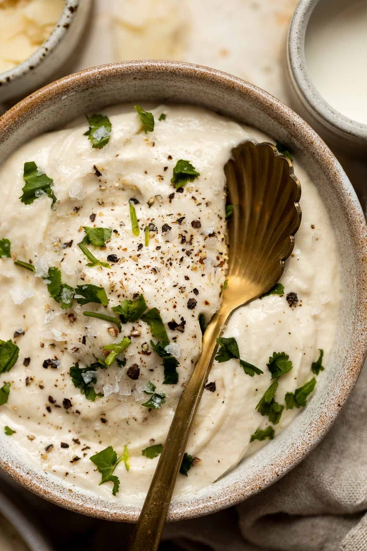 Mashed Cauliflower is a fluffy and buttery side dish and a low carb, keto-friendly alternative to mashed potatoes. Plus, it’s easier and quicker too! | aheadofthyme.com