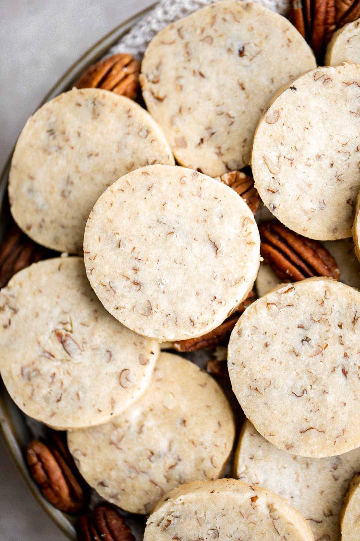 Pecan Sandies are easy, slice and bake shortbread cookies loaded with pecans and literally melt in your mouth. They’re sweet, buttery, nutty, and delicious. | aheadofthyme.com