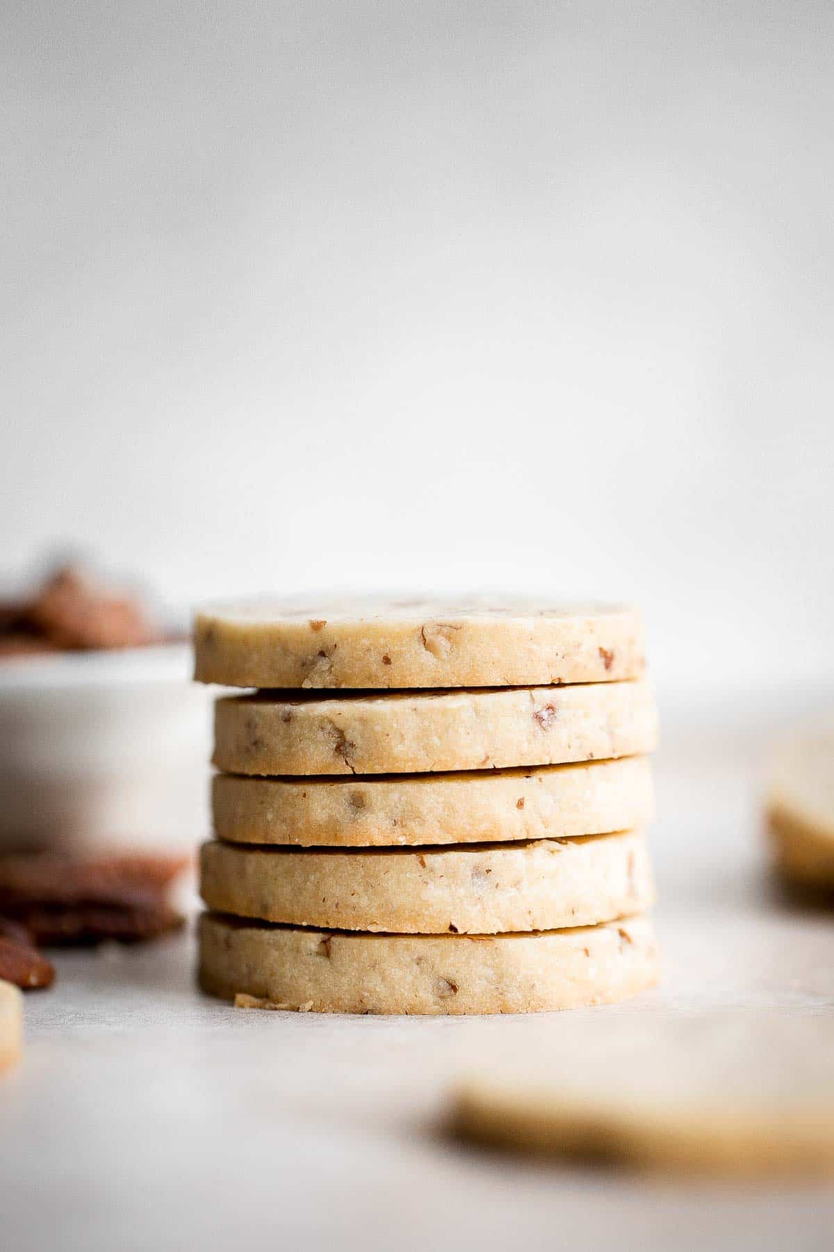 Pecan Sandies are easy, slice and bake shortbread cookies loaded with pecans and literally melt in your mouth. They’re sweet, buttery, nutty, and delicious. | aheadofthyme.com