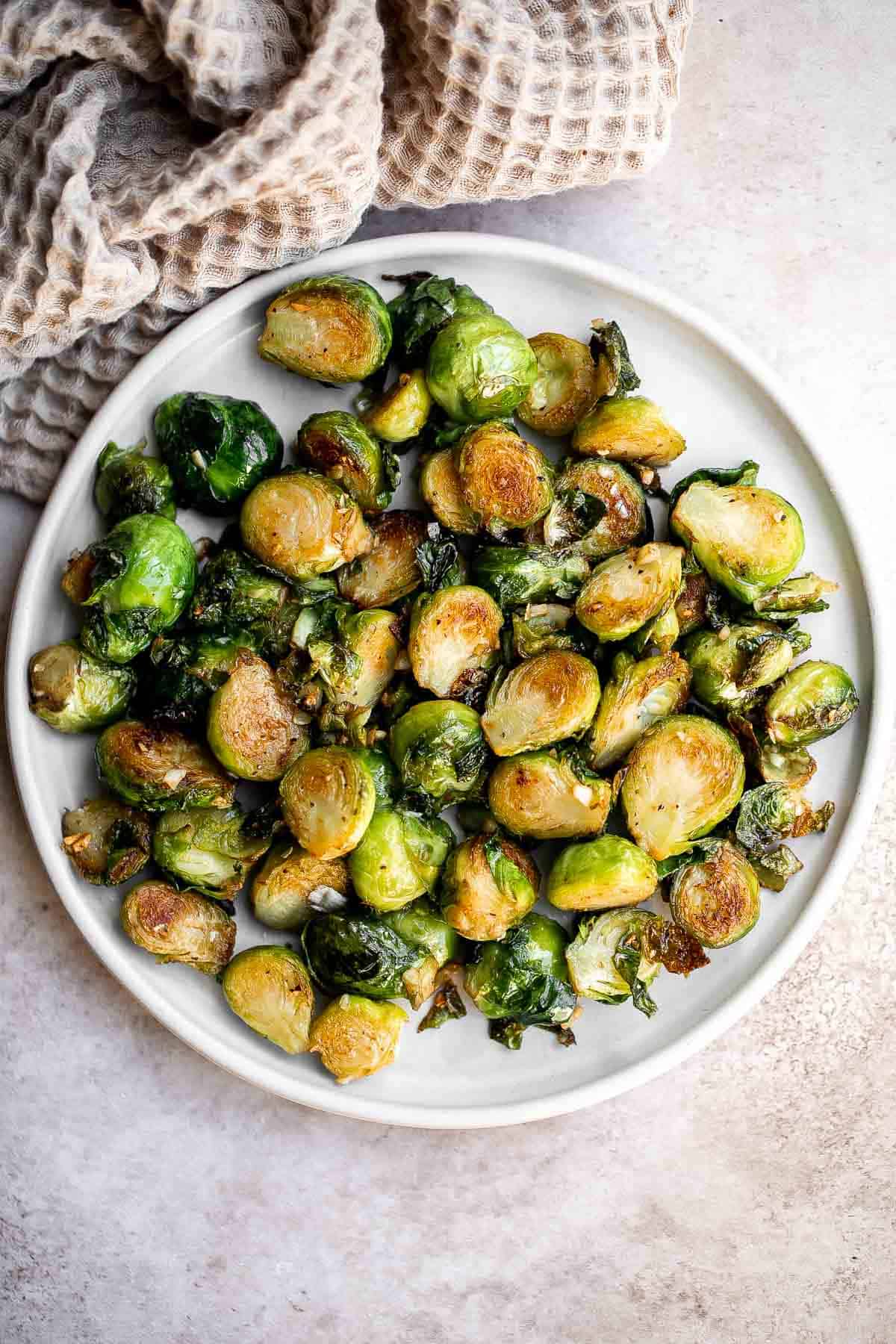 Sautéed Brussels Sprouts are a quick and easy side dish made with just 5 ingredients and ready to serve in only 15 minutes. They're vegan and keto too. | aheadofthyme.com