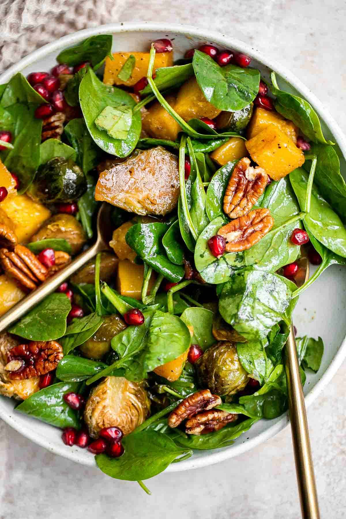 This simple and healthy Thanksgiving Salad is loaded with greens, seasonal veggies, pomegranate seeds, and pecans, all tossed in a homemade vinaigrette. | aheadofthyme.com