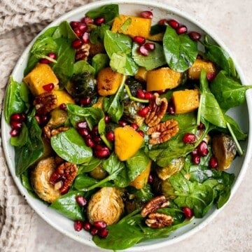 This simple and healthy Thanksgiving Salad is loaded with greens, seasonal veggies, pomegranate seeds, and pecans, all tossed in a homemade vinaigrette. | aheadofthyme.com