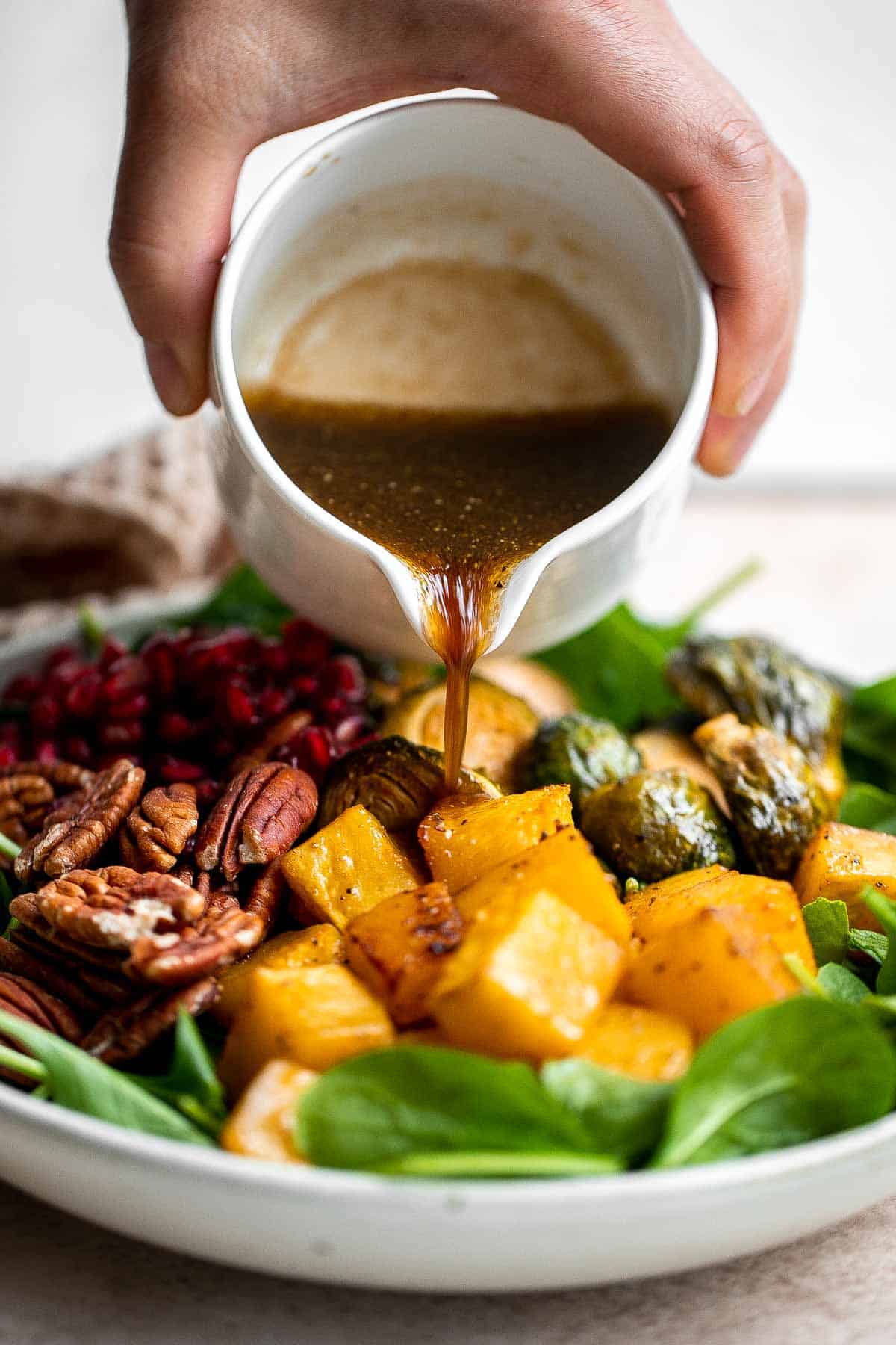 This simple and healthy Thanksgiving Salad is loaded with greens, seasonal veggies, pomegranate seeds, and pecans, all tossed in a homemade vinaigrette. | aheadofthyme.com