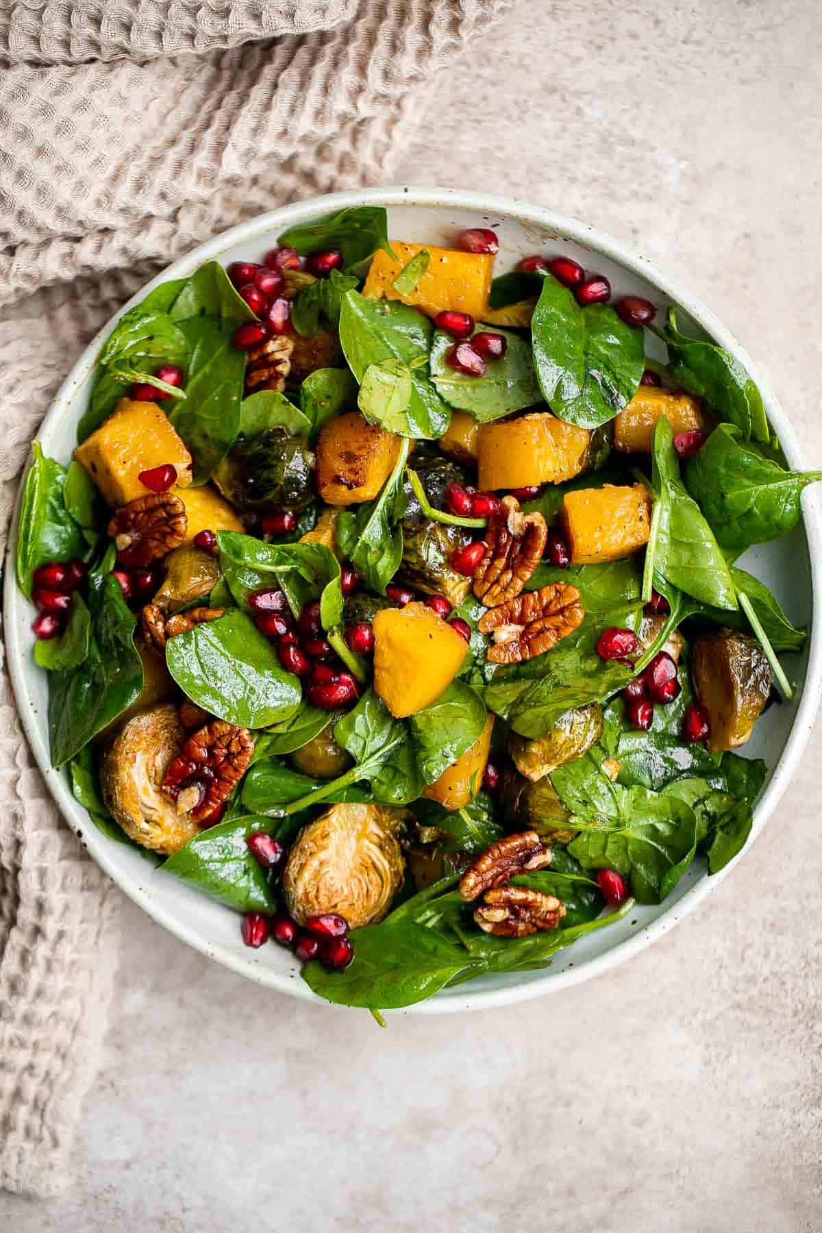 This simple and healthy Thanksgiving Salad is loaded with greens, seasonal veggies, pomegranate seeds, and pecans, all tossed in a homemade vinaigrette. | aheadofthyme.com