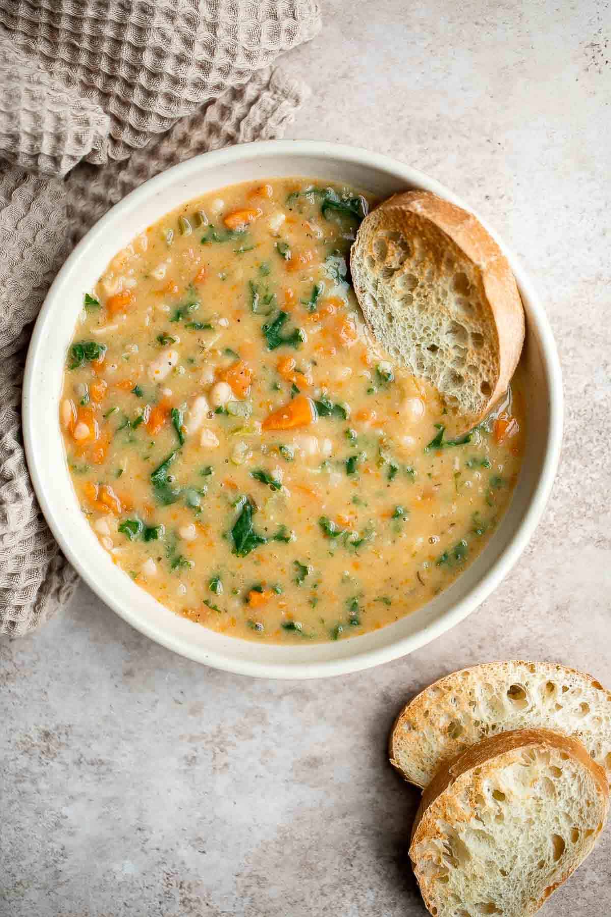 White Bean Soup with Kale is a hearty and nourishing one-pot meal that is flavorful and easy. Make this healthy soup in 30 minutes using simple ingredients. | aheadofthyme.com