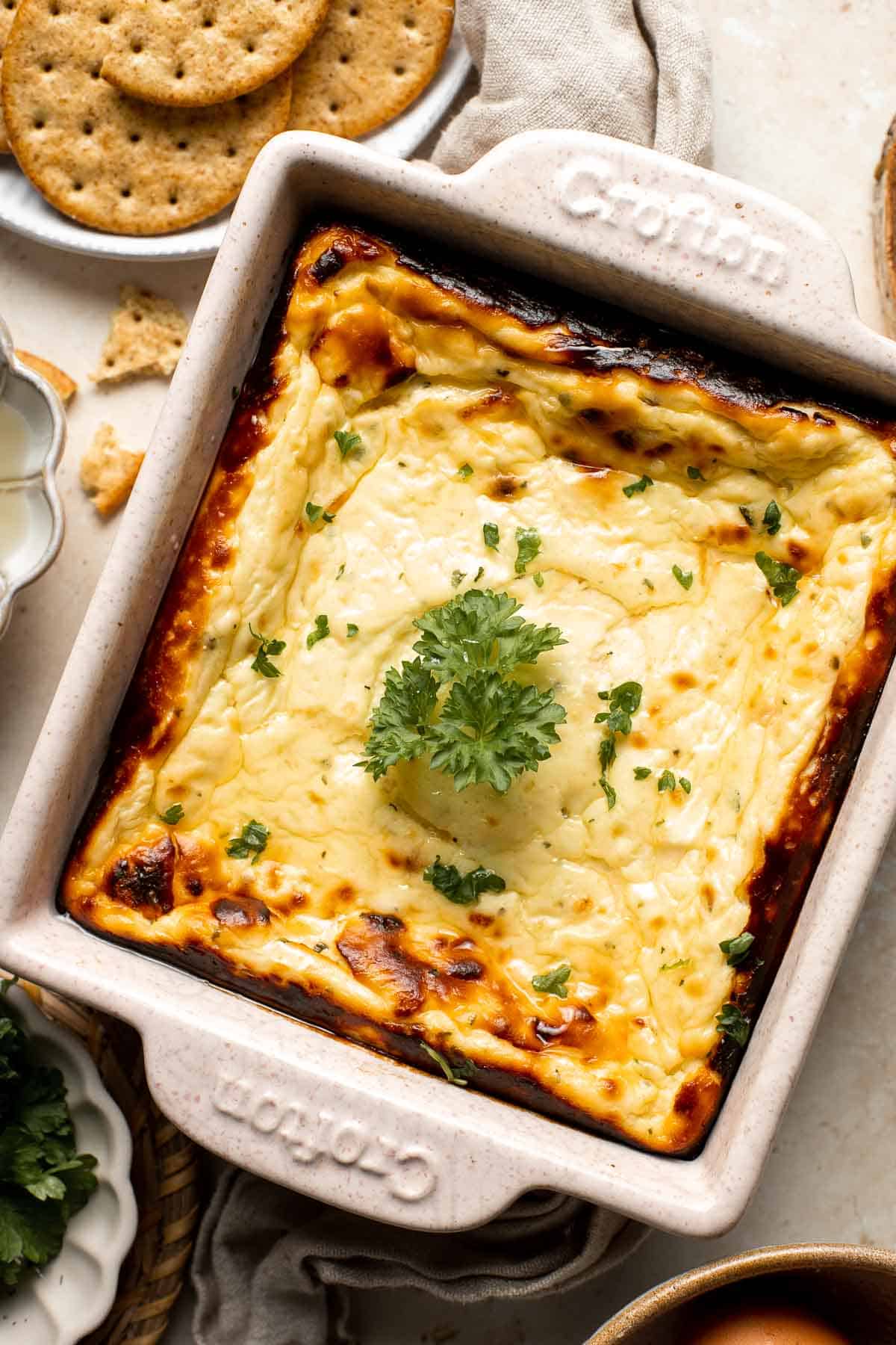 Baked ricotta is creamy, smooth, and flavorful. This delicious warm dip is packed with Parmesan and seasoned with dried herbs for the ultimate cheesy dip. | aheadofthyme.com