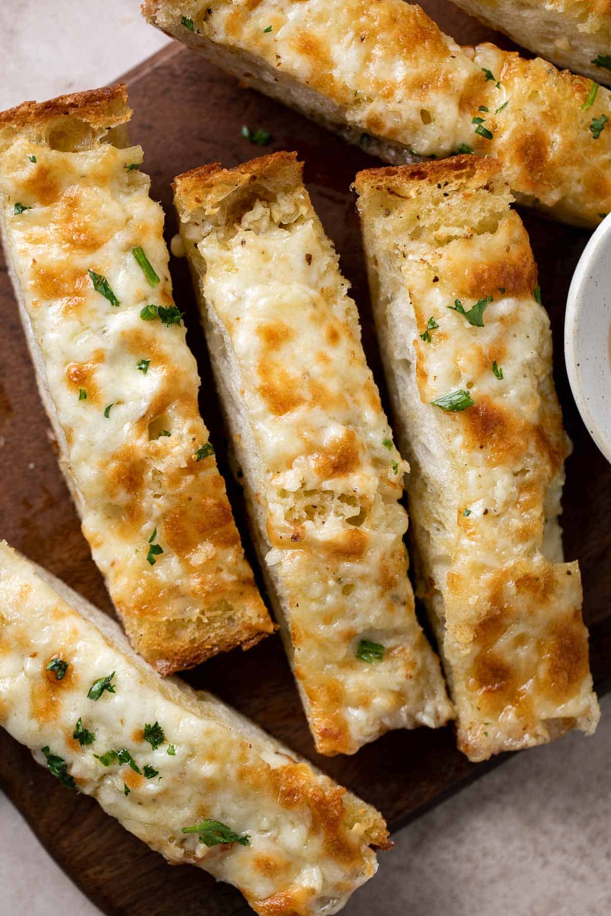 Cheesy Garlic Bread is toasty and crispy on the outside, tender and soft inside with a garlic butter and melty cheese on top. Make in under 20 minutes! | aheadofthyme.com