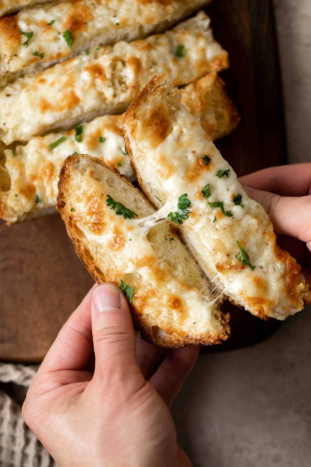 Cheesy Garlic Bread is toasty and crispy on the outside, tender and soft inside with a garlic butter and melty cheese on top. Make in under 20 minutes! | aheadofthyme.com