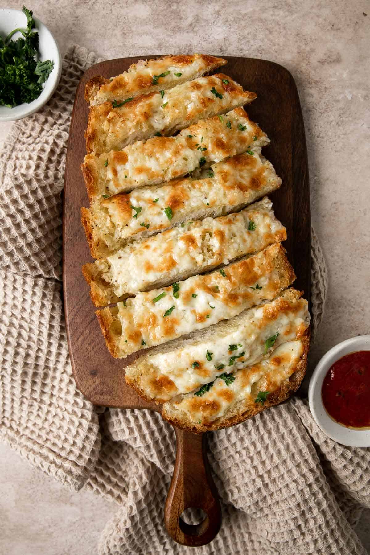 Cheesy Garlic Bread is toasty and crispy on the outside, tender and soft inside with a garlic butter and melty cheese on top. Make in under 20 minutes! | aheadofthyme.com