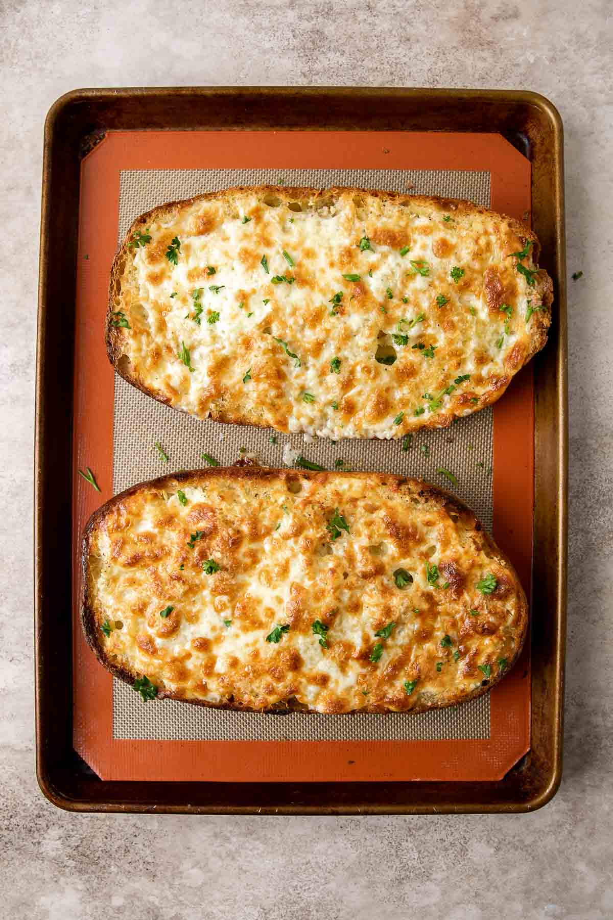 Cheesy Garlic Bread is toasty and crispy on the outside, tender and soft inside with a garlic butter and melty cheese on top. Make in under 20 minutes! | aheadofthyme.com