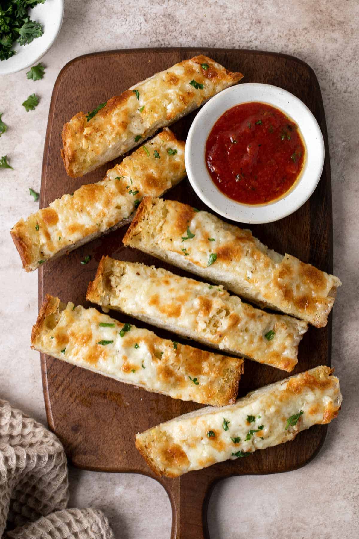 Cheesy Garlic Bread is toasty and crispy on the outside, tender and soft inside with a garlic butter and melty cheese on top. Make in under 20 minutes! | aheadofthyme.com