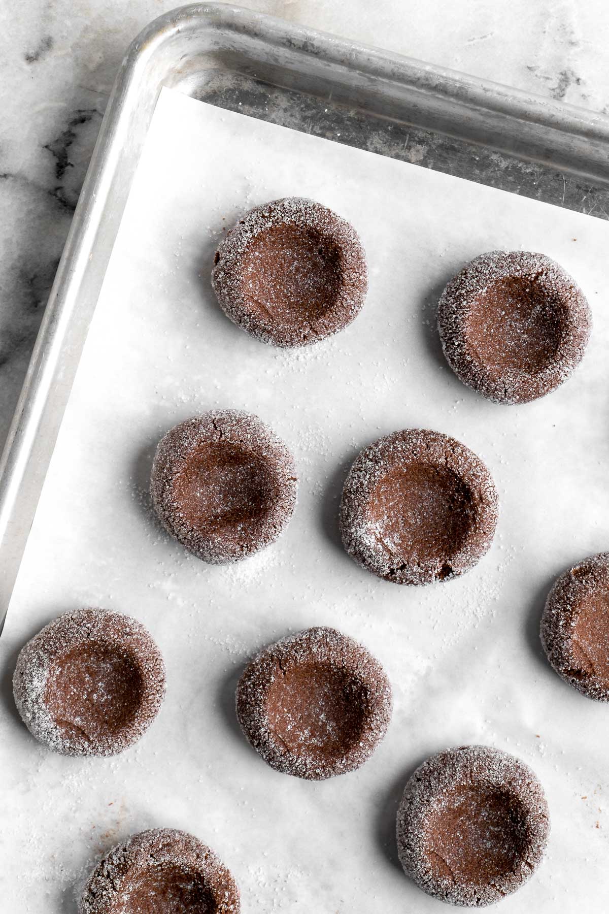 Chocolate Thumbprint Cookies are rich and chewy chocolate cookies with a smooth and velvety chocolate ganache filling topped with crunchy pistachios. | aheadofthyme.com