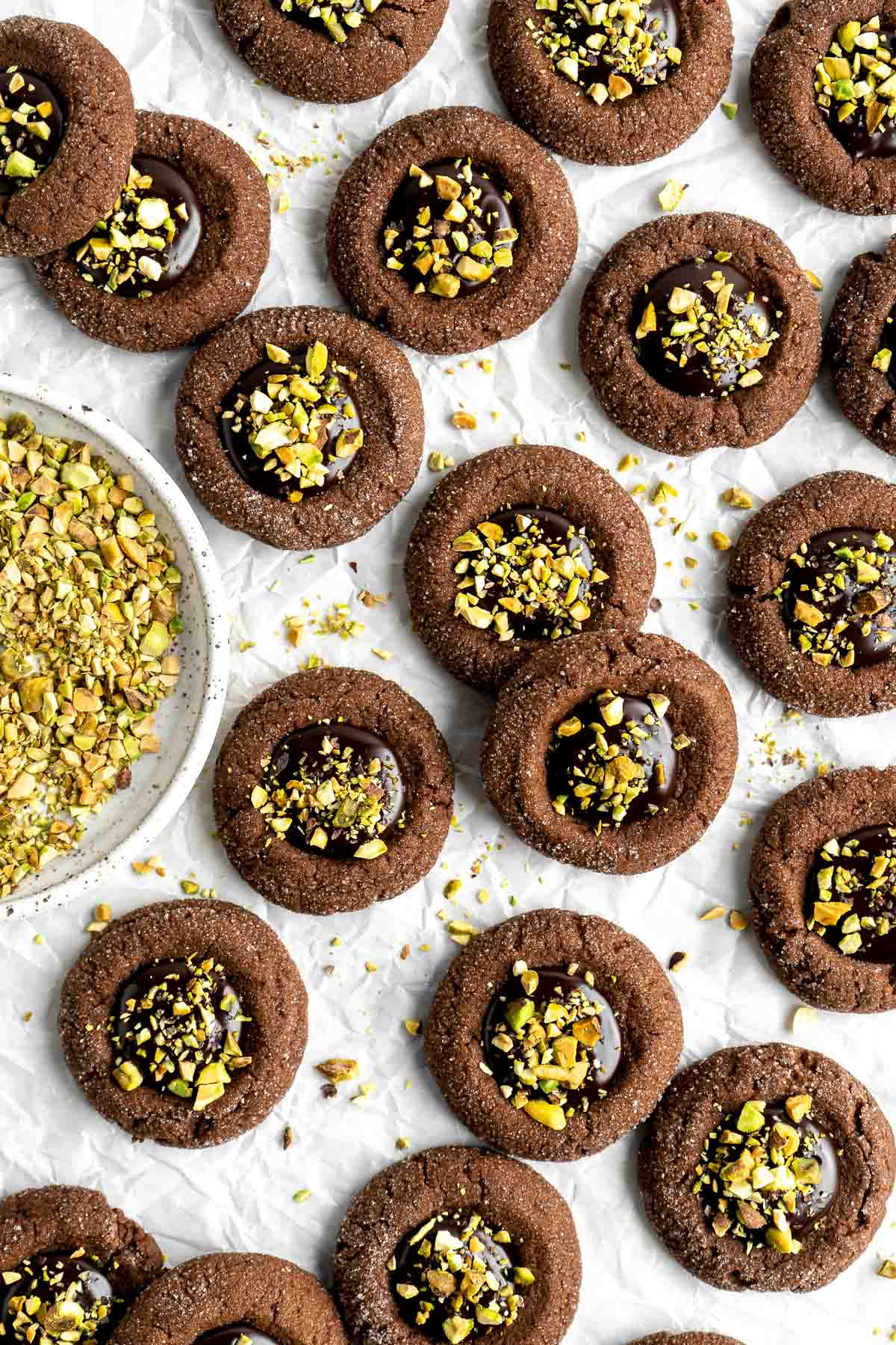 Chocolate Thumbprint Cookies are rich and chewy chocolate cookies with a smooth and velvety chocolate ganache filling topped with crunchy pistachios. | aheadofthyme.com