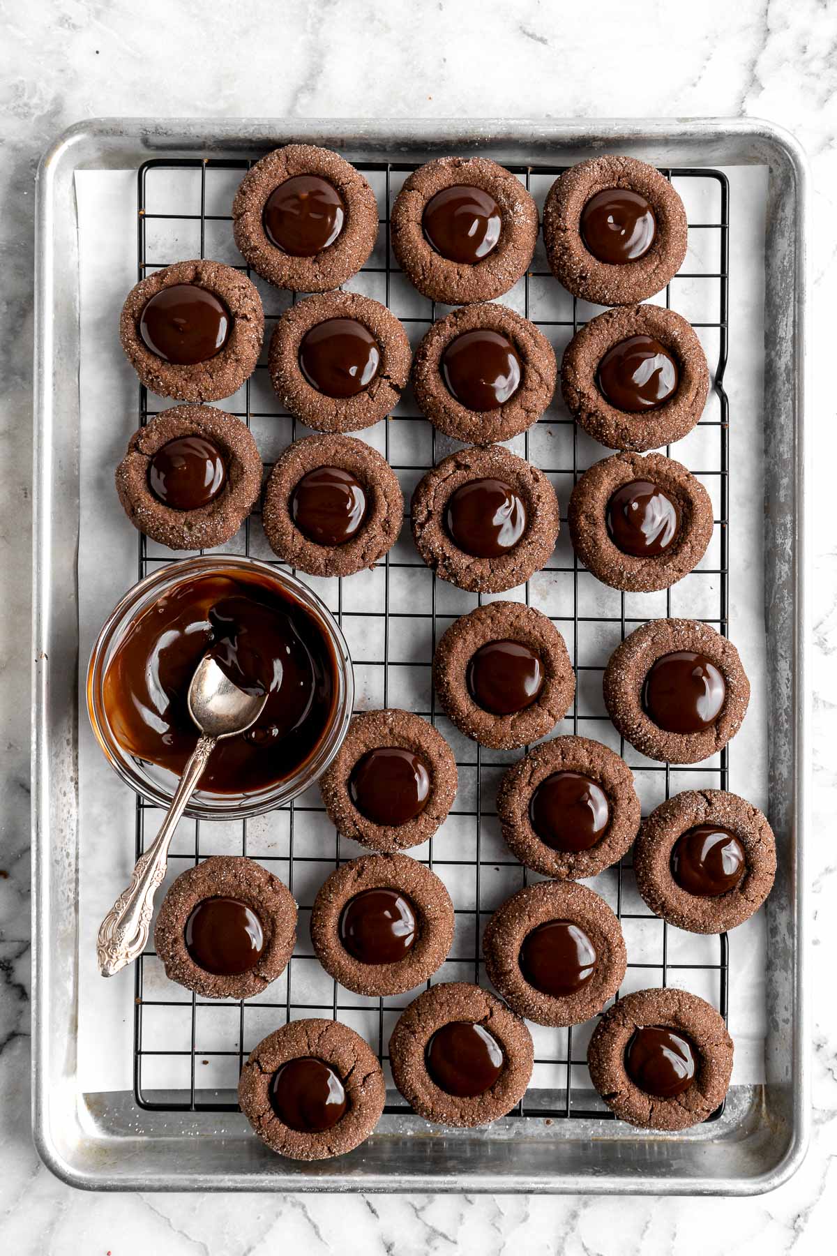 Chocolate Thumbprint Cookies are rich and chewy chocolate cookies with a smooth and velvety chocolate ganache filling topped with crunchy pistachios. | aheadofthyme.com