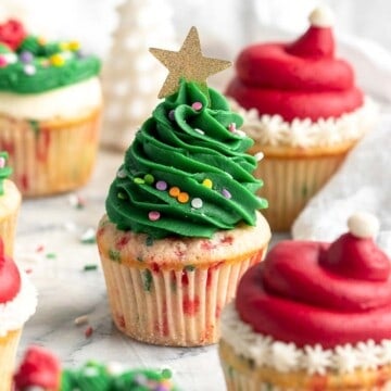 These festive Christmas Cupcakes are made of moist and fluffy vanilla funfetti cake topped with red and green buttercream frosting. So fun to make! | aheadofthyme.com