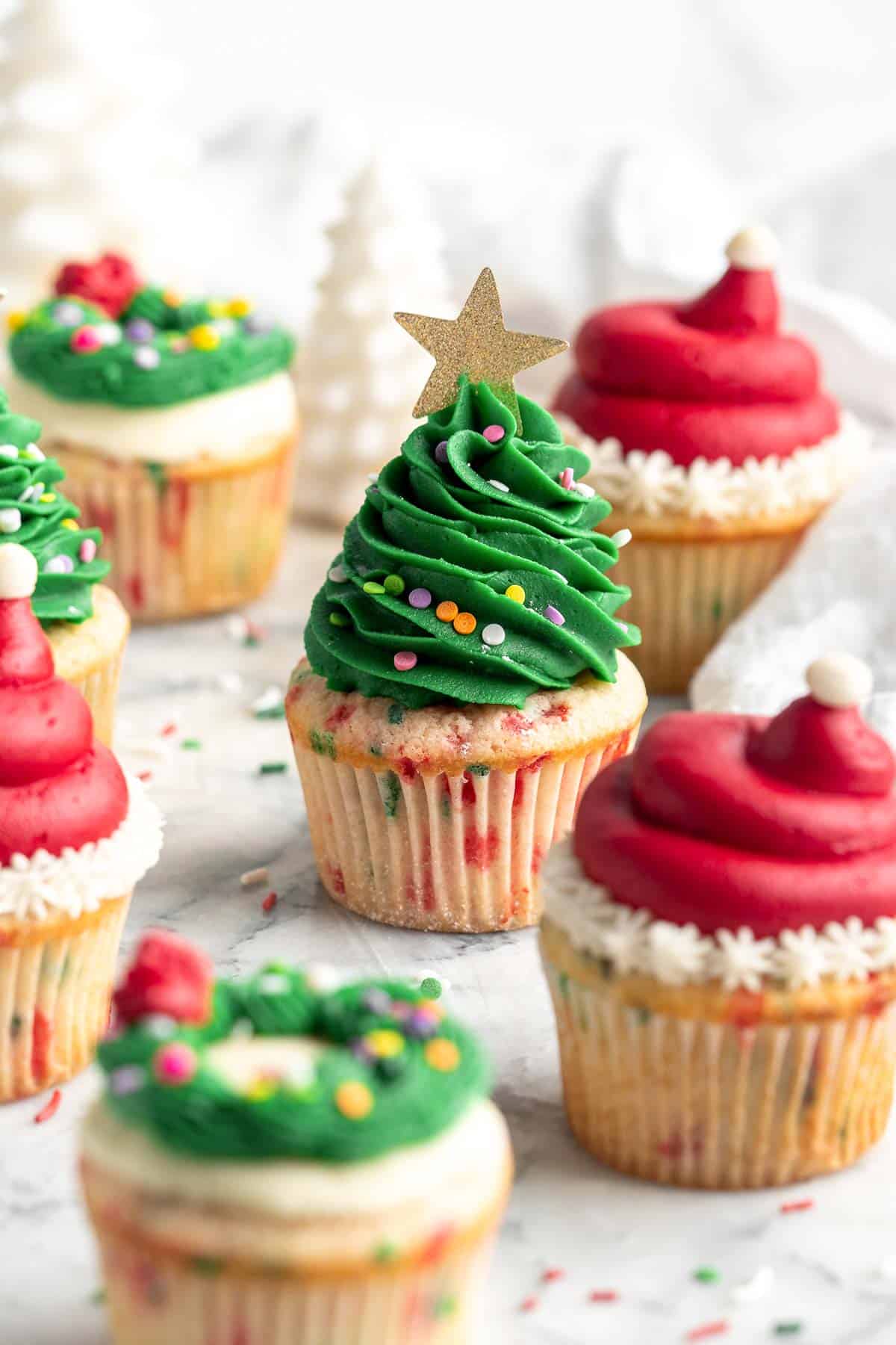 These festive Christmas Cupcakes are made of moist and fluffy vanilla funfetti cake topped with red and green buttercream frosting. So fun to make! | aheadofthyme.com