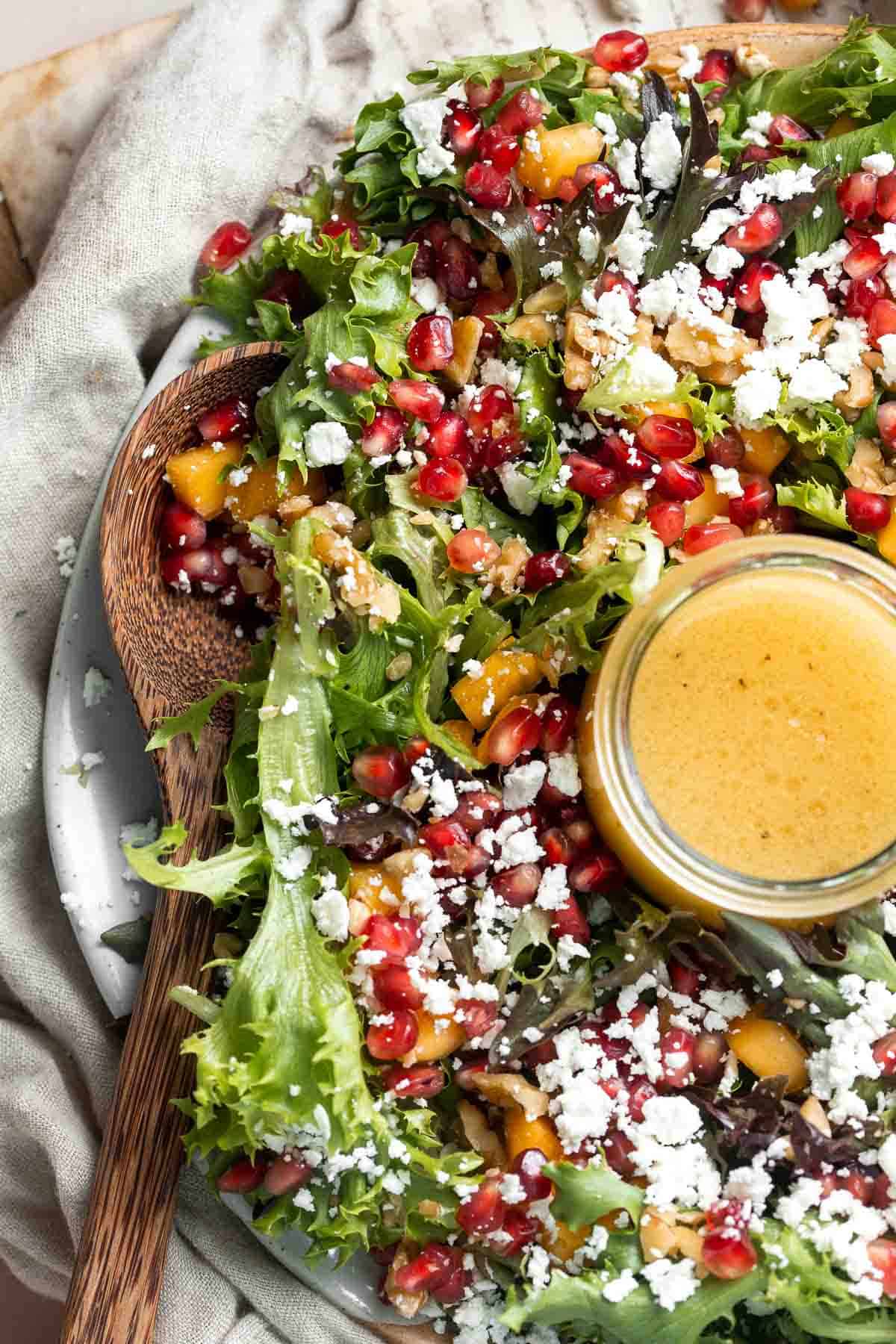 This fresh and festive Christmas Salad is made with delicious winter fruits and has a gorgeous wreath-like appearance. It’s earthy, sweet, nutty, and tangy. | aheadofthyme.com