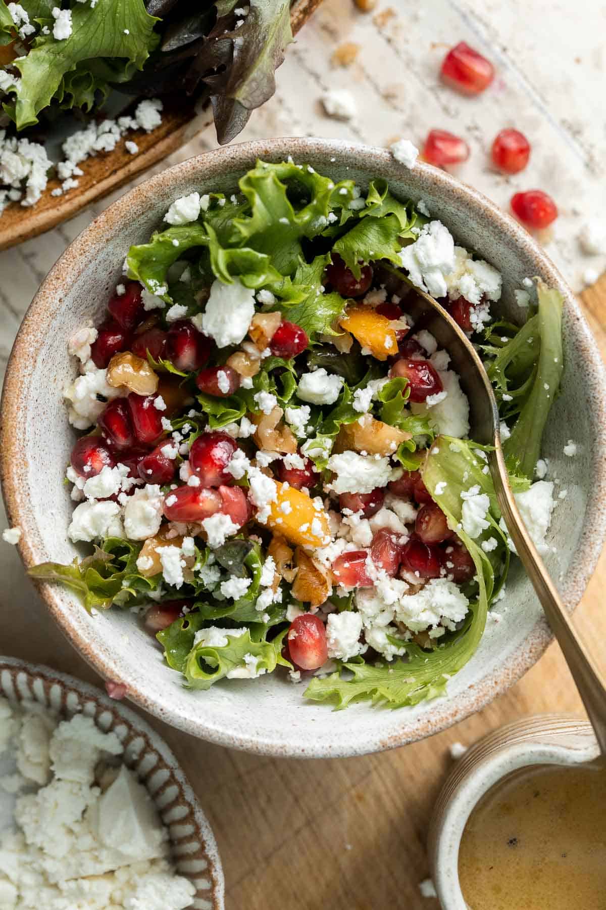 This fresh and festive Christmas Salad is made with delicious winter fruits and has a gorgeous wreath-like appearance. It’s earthy, sweet, nutty, and tangy. | aheadofthyme.com