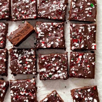 Peppermint Brownies are rich and decadent with a fudgy brownie base, a delicious minty chocolate ganache layer, and crushed candy canes sprinkled on top. | aheadofthyme.com