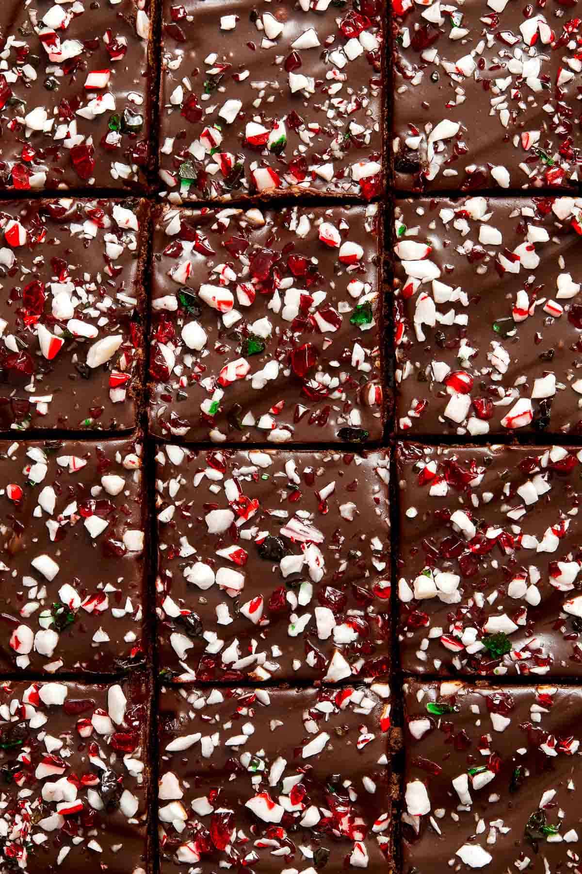 Peppermint Brownies are rich and decadent with a fudgy brownie base, a delicious minty chocolate ganache layer, and crushed candy canes sprinkled on top. | aheadofthyme.com