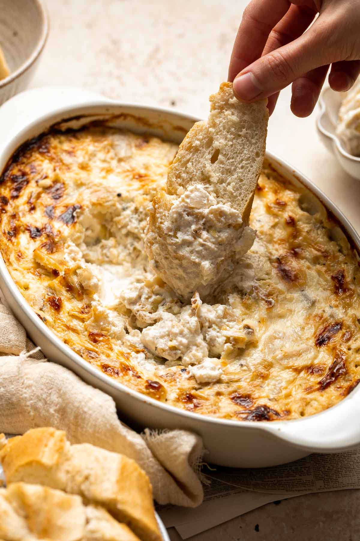 Homemade artichoke dip is a warm, creamy dip loaded with tender artichoke hearts. This easy to make appetizer is tangy, cheesy, and all-around delicious! | aheadofthyme.com