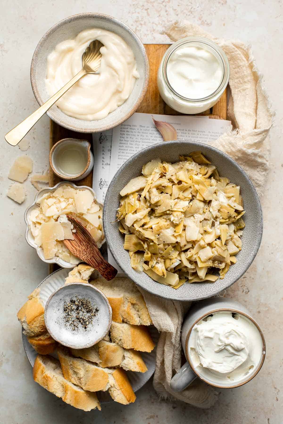 Homemade artichoke dip is a warm, creamy dip loaded with tender artichoke hearts. This easy to make appetizer is tangy, cheesy, and all-around delicious! | aheadofthyme.com