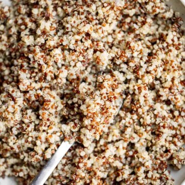 Making perfect fluffy quinoa at home is quick and a lot easier than you think! Learn how to cook quinoa perfectly every time using our simple recipe. | aheadofthyme.com