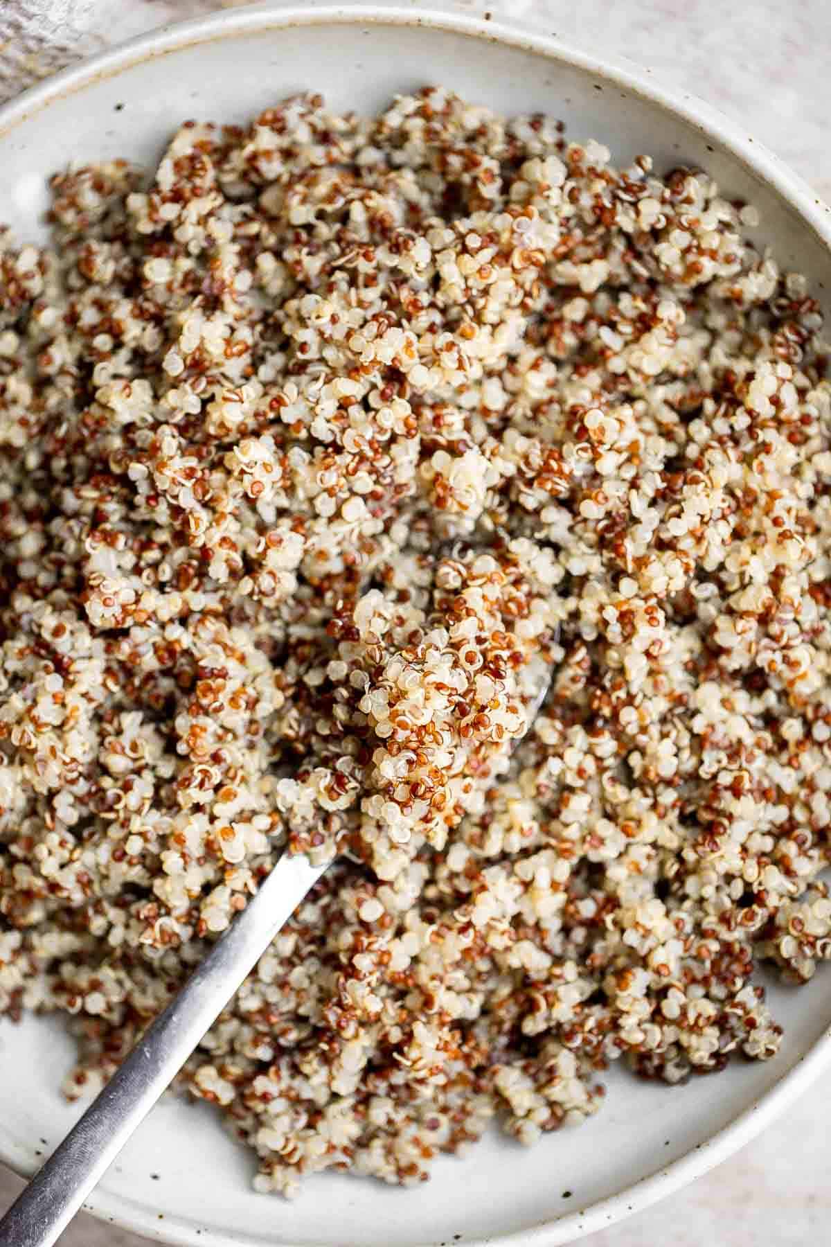 Making perfect fluffy quinoa at home is quick and a lot easier than you think! Learn how to cook quinoa perfectly every time using our simple recipe. | aheadofthyme.com