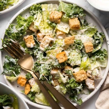 Kale Caesar Salad is a delicious, healthy twist on classic Caesar salad with all the traditional flavors but added crunch and rich earthiness of fresh kale. | aheadofthyme.com