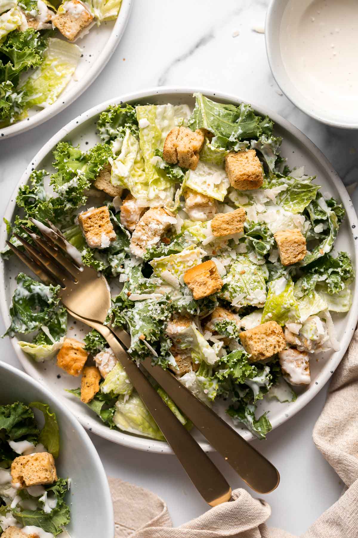 Kale Caesar Salad is a delicious, healthy twist on classic Caesar salad with all the traditional flavors but added crunch and rich earthiness of fresh kale. | aheadofthyme.com