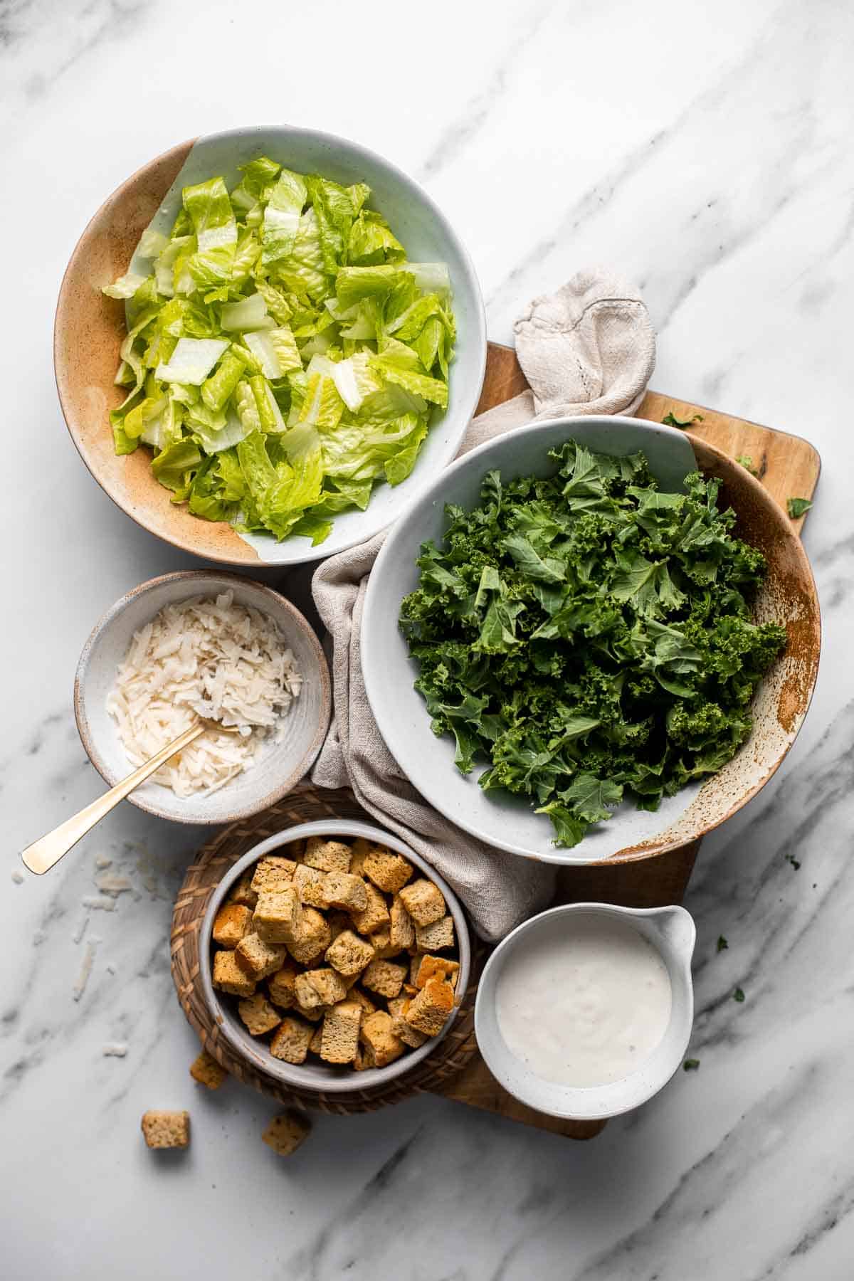 Kale Caesar Salad is a delicious, healthy twist on classic Caesar salad with all the traditional flavors but added crunch and rich earthiness of fresh kale. | aheadofthyme.com