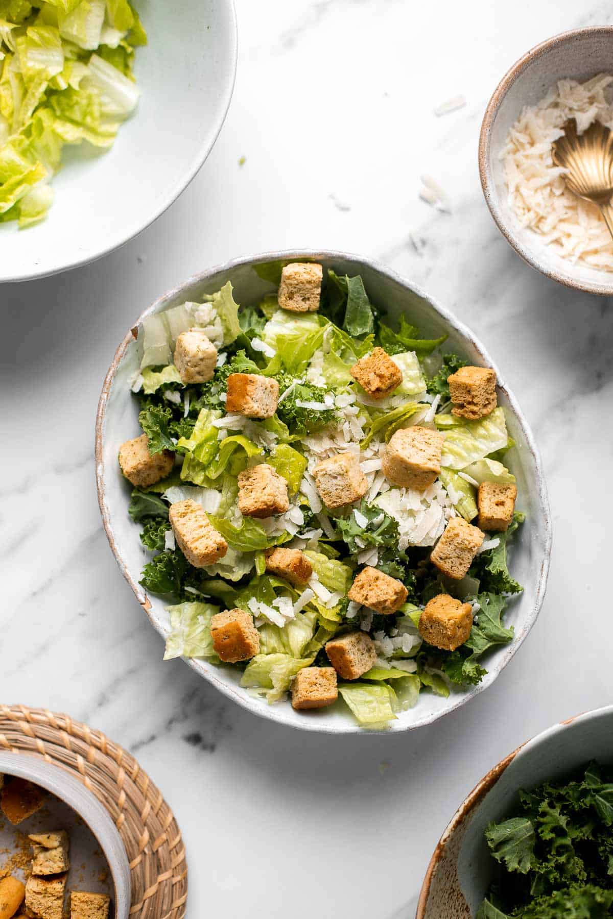 Kale Caesar Salad is a delicious, healthy twist on classic Caesar salad with all the traditional flavors but added crunch and rich earthiness of fresh kale. | aheadofthyme.com