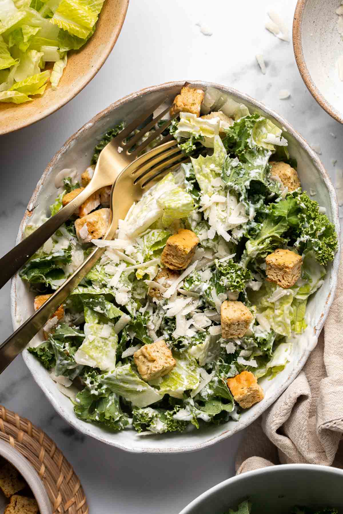 Kale Caesar Salad is a delicious, healthy twist on classic Caesar salad with all the traditional flavors but added crunch and rich earthiness of fresh kale. | aheadofthyme.com