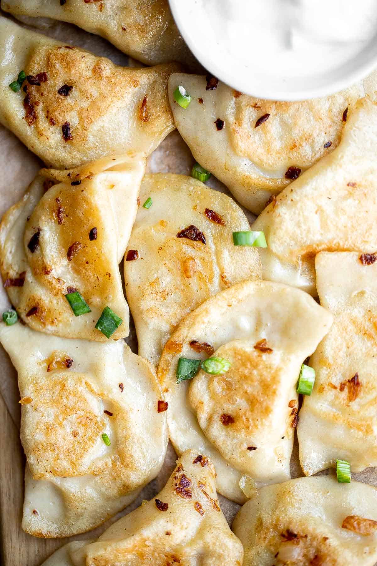 Potato Onion Pierogi is a flavorful delicious dumpling recipe made from scratch with simple ingredients, filled potatoes, caramelized onions, and cheese. | aheadofthyme.com