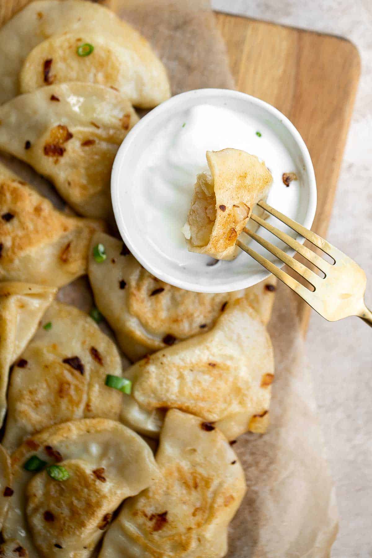 Potato Onion Pierogi is a flavorful delicious dumpling recipe made from scratch with simple ingredients, filled potatoes, caramelized onions, and cheese. | aheadofthyme.com