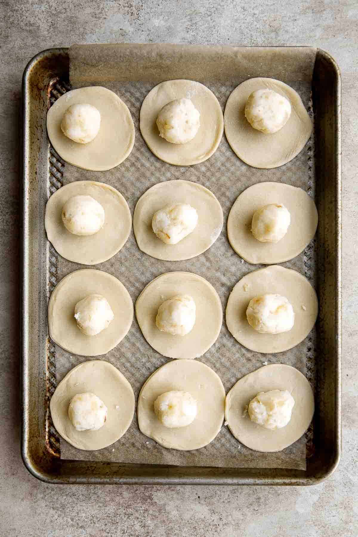 Potato Onion Pierogi is a flavorful delicious dumpling recipe made from scratch with simple ingredients, filled potatoes, caramelized onions, and cheese. | aheadofthyme.com