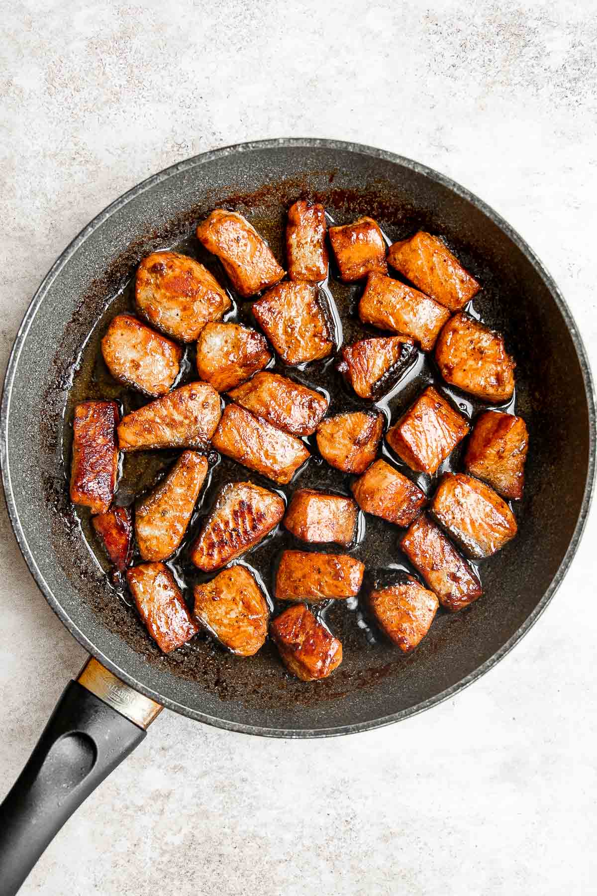 Salmon Bites are flavorful and delicious bite-sized pieces of salmon cooked until tender with crispy, golden edges and coated with an homemade sticky glaze. | aheadofthyme.com