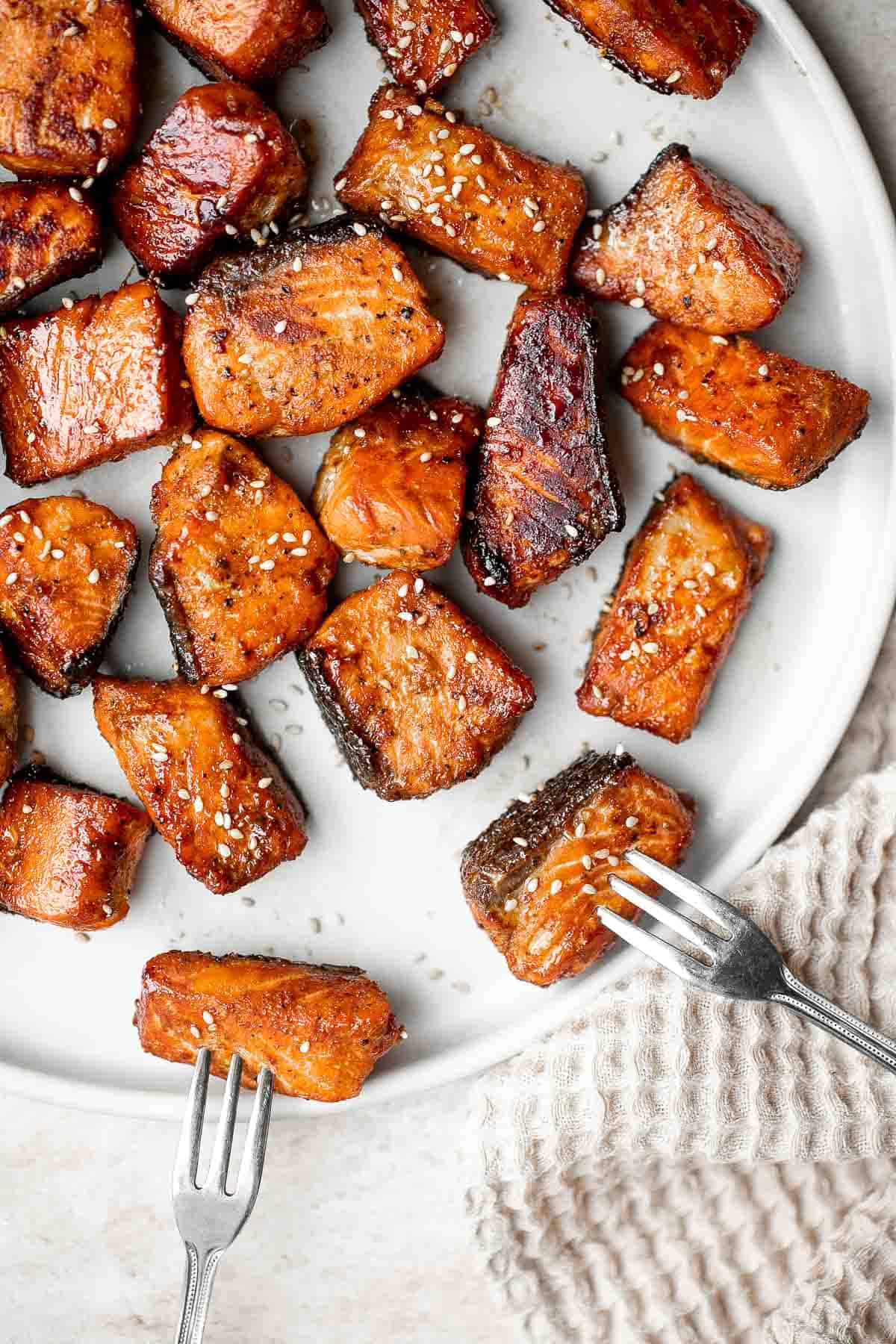 Salmon Bites are flavorful and delicious bite-sized pieces of salmon cooked until tender with crispy, golden edges and coated with an homemade sticky glaze. | aheadofthyme.com