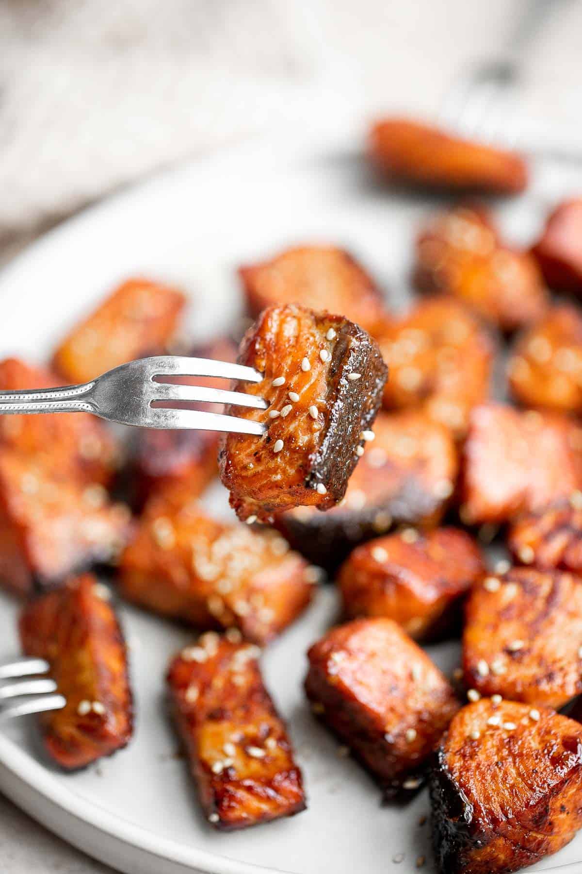 Salmon Bites are flavorful and delicious bite-sized pieces of salmon cooked until tender with crispy, golden edges and coated with an homemade sticky glaze. | aheadofthyme.com