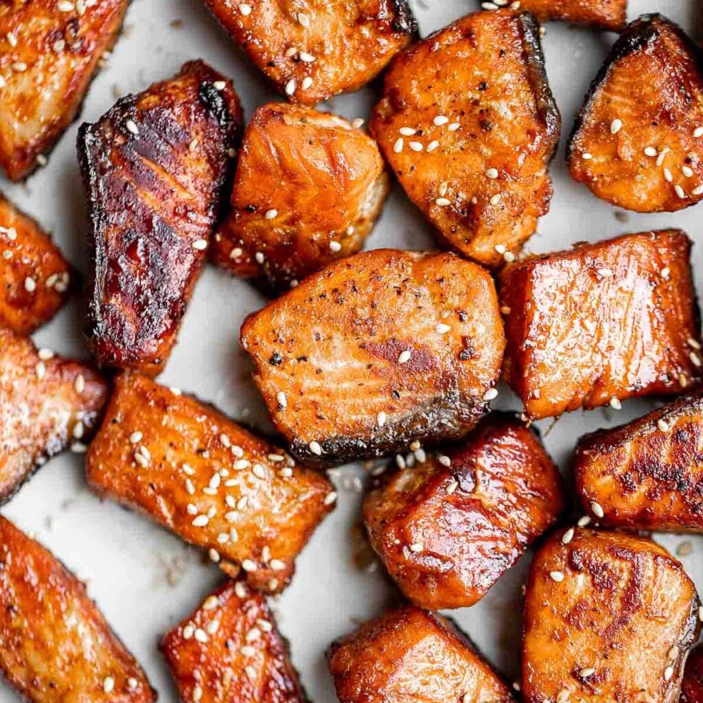 Salmon Bites are flavorful and delicious bite-sized pieces of salmon cooked until tender with crispy, golden edges and coated with an homemade sticky glaze. | aheadofthyme.com