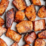 Salmon Bites are flavorful and delicious bite-sized pieces of salmon cooked until tender with crispy, golden edges and coated with an homemade sticky glaze. | aheadofthyme.com