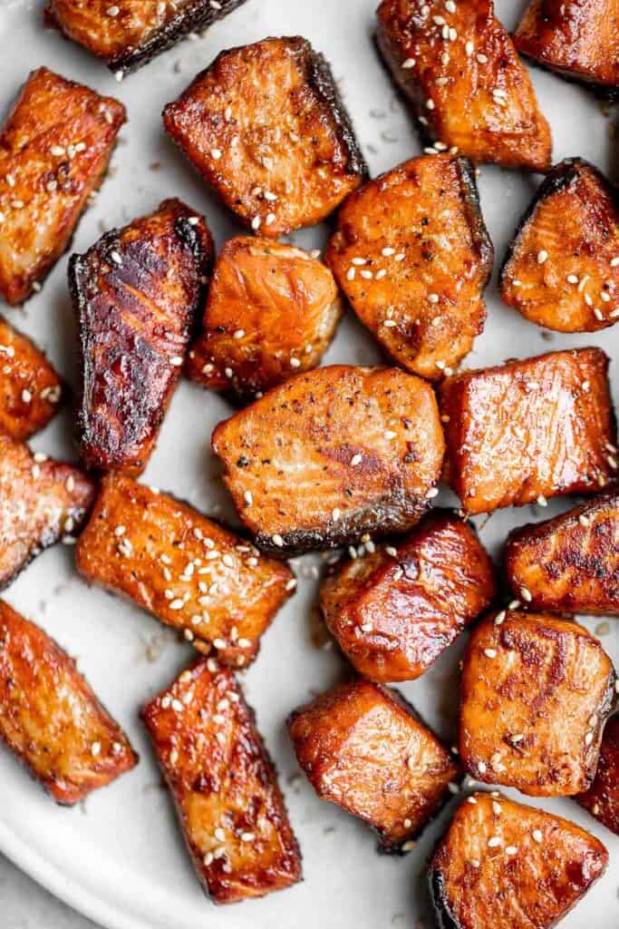 Salmon Bites are flavorful and delicious bite-sized pieces of salmon cooked until tender with crispy, golden edges and coated with an homemade sticky glaze. | aheadofthyme.com