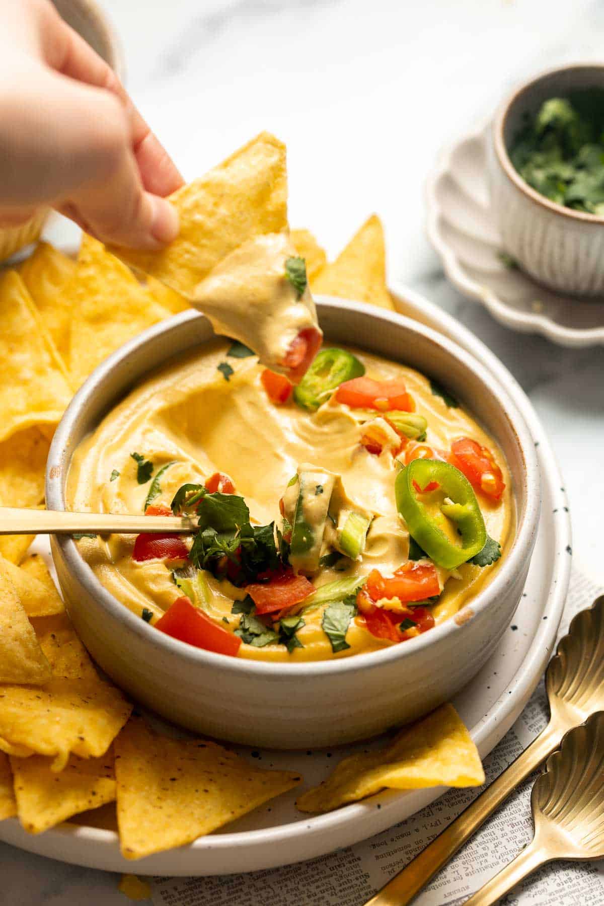 Vegan Queso is a 5-minute dip that is creamy, cheesy, and perfectly spiced to mimic the classic dip — without any dairy! It tastes like the real thing! | aheadofthyme.com