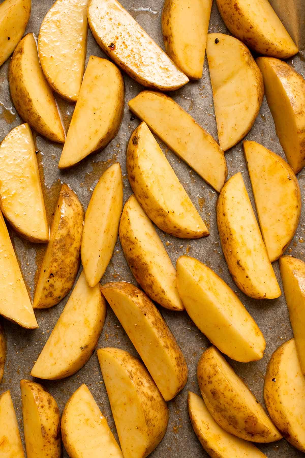 Baked Potato Wedges are crispy outside and soft inside — exactly what you want from a potato wedge but without frying! Cook in the oven or air fryer. | aheadofthyme.com