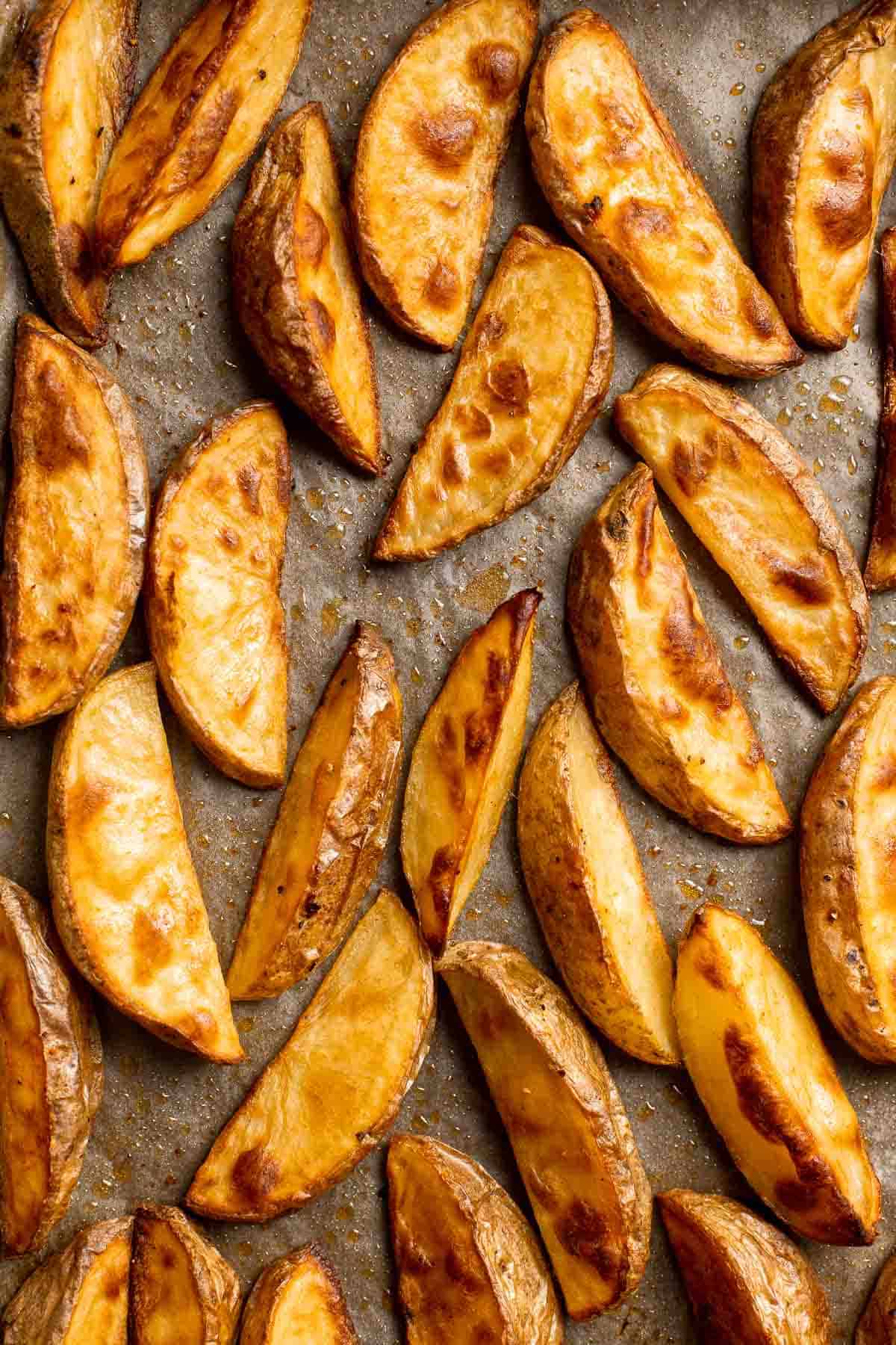 Baked Potato Wedges are crispy outside and soft inside — exactly what you want from a potato wedge but without frying! Cook in the oven or air fryer. | aheadofthyme.com