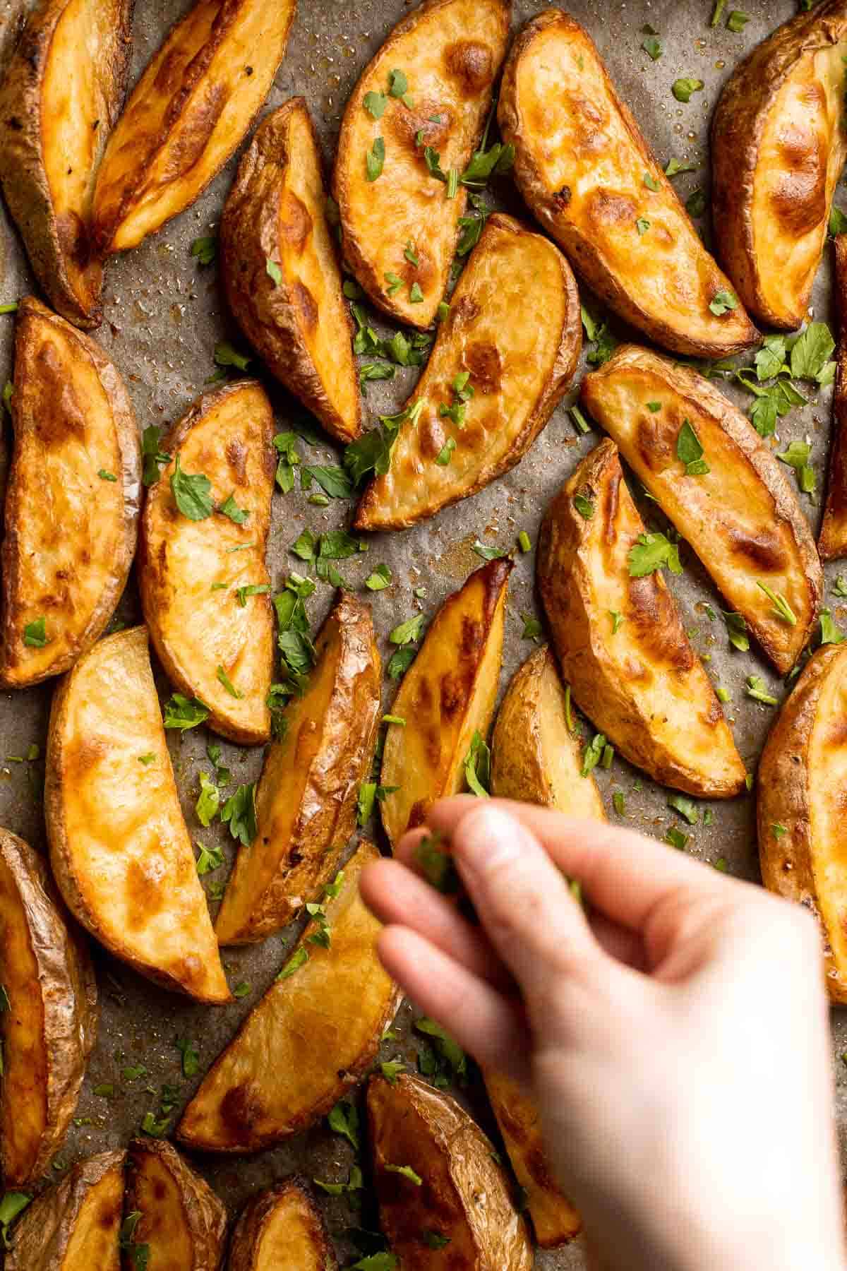 Baked Potato Wedges are crispy outside and soft inside — exactly what you want from a potato wedge but without frying! Cook in the oven or air fryer. | aheadofthyme.com